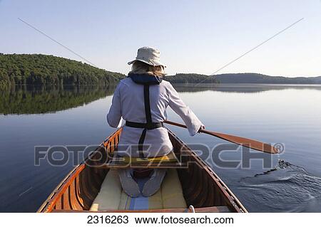Senior Woman Paddling Her Canoe On A Sunny Morning In Algonquin Park; Ontario Canada View Large Photo Image Stock Image - Senior Woman Paddling Her Canoe On A Sunny Morning In Algonquin Park; Ontario Canada. Fotosearch