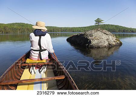 Senior Woman Paddling Her Canoe On A Sunny Morning In Algonquin Park; Ontario Canada View Large Photo Image Stock Photo - Senior Woman Paddling Her Canoe On A Sunny Morning In Algonquin Park; Ontario Canada. Fotosearch