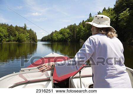 Senior Woman Piloting Her Boat In Algonquin Park; Ontario Canada View Large Photo Image Stock Image - Senior Woman Piloting Her Boat In Algonquin Park; Ontario Canada. Fotosearch