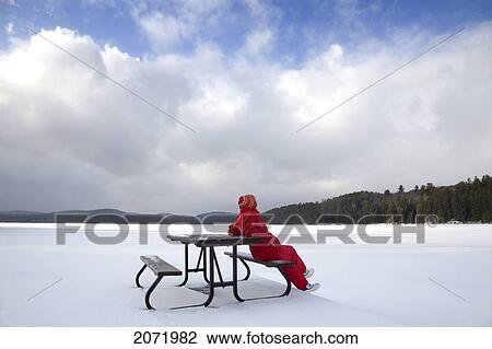 Senior Woman Sitting On A Picnic Table In Snow By A Frozen Lake, Algonquin Park, Ontario View Large Photo Image Stock Image - Senior Woman Sitting On A Picnic Table In Snow By A Frozen Lake, Algonquin Park, Ontario. Fotosearch