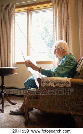 Senior Women Reading Newspaper By Window, Charlottetown Pei View Large Photo Image Stock Photo - Senior Women Reading Newspaper By Window, Charlottetown Pei. Fotosearch