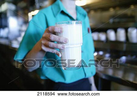 Server Holding Glass Of Milk In Diner; Oshawa Ontario Canada View Large Photo Image Picture - Server Holding Glass Of Milk In Diner; Oshawa Ontario Canada. Fotosearch