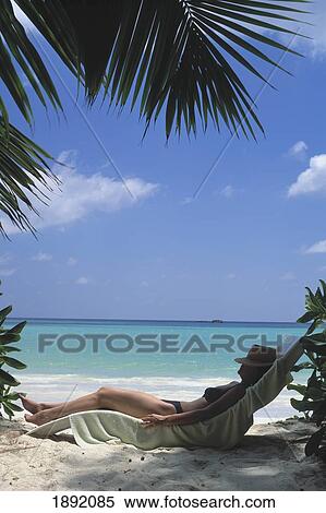 Seychelles, Praslin, Woman Relaxing On Beach; Cote D'Or Beach View Large Photo Image Stock Photography - Seychelles, Praslin, Woman Relaxing On Beach; Cote D'Or Beach. Fotosearch