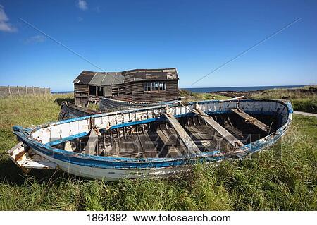 Stock Image - Shack And Broken Boat. Fotosearch