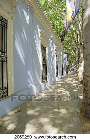 Stock Image - Shaded Street Alongside A Building In South America; Mendoza Argentina. Fotosearch