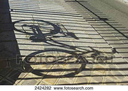 Shadow of a bicycle and fence along a walkway, Marais district; Paris, France View Large Photo Image Stock Image - Shadow of a bicycle and fence along a walkway, Marais district; Paris, France. Fotosearch
