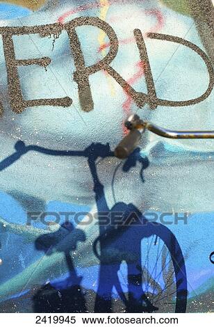 Shadow of a bicycle over spray painted graffiti on a wall; Hamburg, Germany View Large Photo Image Stock Photography - Shadow of a bicycle over spray painted graffiti on a wall; Hamburg, Germany. Fotosearch