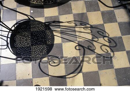 Stock Photo - Shadow Of Chair On Tiled Floor. Fotosearch