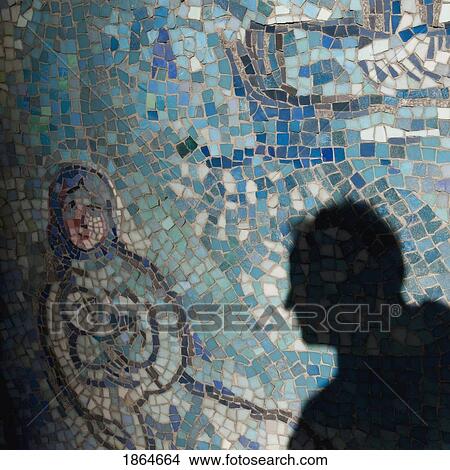 Picture - Shadow Of Man On Mosaic Tiles. Fotosearch