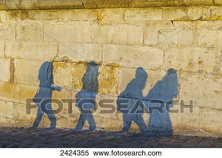 Shadows of pedestrians cast on a wall; Paris, France View Large Photo Image Stock Photography - Shadows of pedestrians cast on a wall; Paris, France. Fotosearch