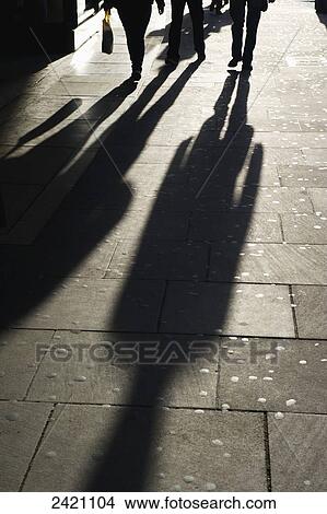 Shadows of pedestrians cast on the sidewalk; London, England View Large Photo Image Picture - Shadows of pedestrians cast on the sidewalk; London, England. Fotosearch