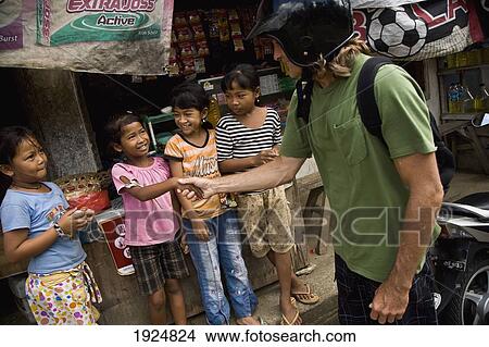 Picture - Shaking Hands With Local Children. Fotosearch