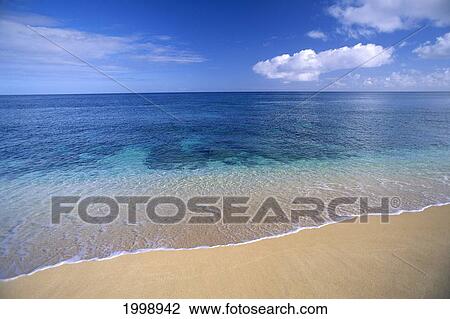 Stock Image - Shallow Reef Water Washing Upon Sand B1462. Fotosearch