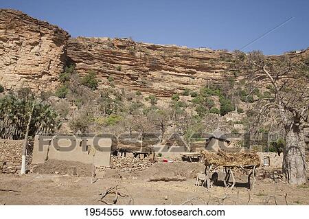 Sheds for animal against large rock in Baniani, Mali View Large Photo Image Stock Photography - Sheds for animal against large rock in Baniani, Mali. Fotosearch