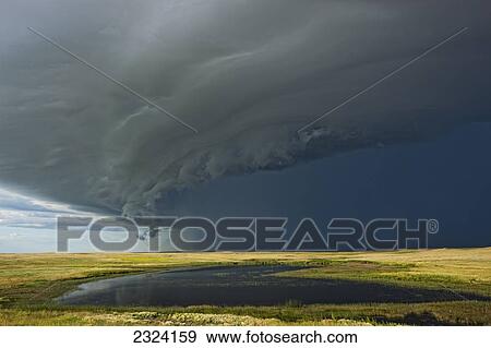 Shelf cloud heralds an approaching thunderstorm over Grasslands National Park; Saskatchewan, Canada View Large Photo Image Stock Photo - Shelf cloud heralds an approaching thunderstorm over Grasslands National Park; Saskatchewan, Canada. Fotosearch