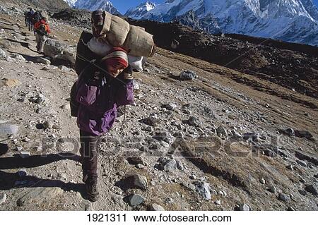 Sherpa Carrying Heavy Load In Mountains View Large Photo Image Stock Image - Sherpa Carrying Heavy Load In Mountains. Fotosearch