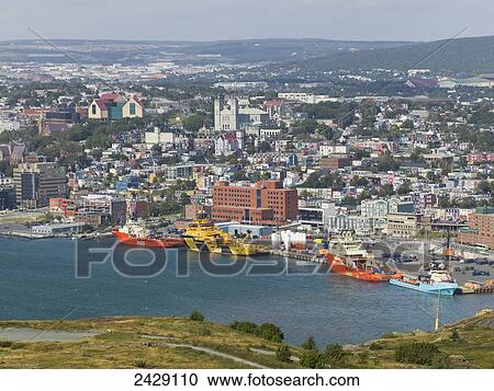 Ships in the harbour with a cityscape; St. John's, Newfoundland, Canada View Large Photo Image Stock Image - Ships in the harbour with a cityscape; St. John's, Newfoundland, Canada. Fotosearch