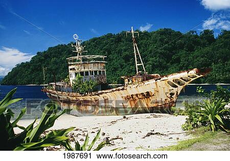 Shipwrecked fishing boat on beach; Papua New Guinea View Large Photo Image Stock Image - Shipwrecked fishing boat on beach; Papua New Guinea. Fotosearch
