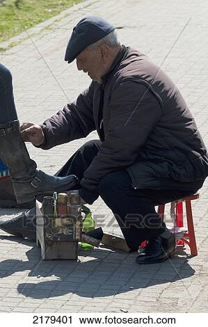 Stock Image - Shoe Shiner In The Street; Istanbul Turkey. Fotosearch