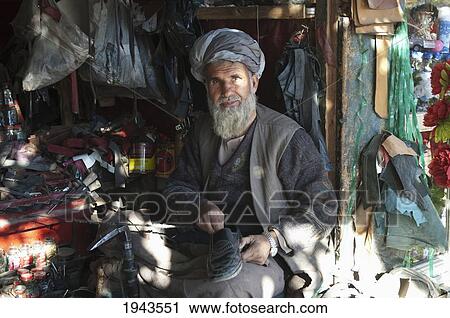 Stock Image - Shoemaker In Charikar, Parwan Province, Afghanistan. Fotosearch