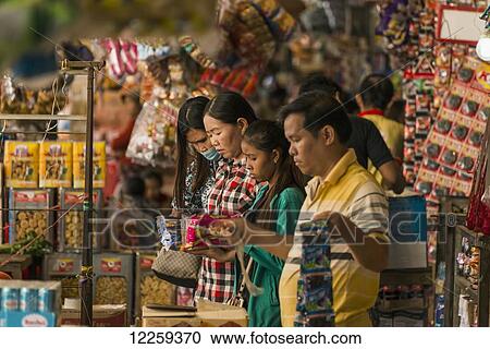 Stock Image - Shoppers and vendors at the Old Market; Battambang, Cambodia. Fotosearch