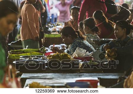 Stock Photo - Shoppers and vendors at the Old Market; Battambang, Cambodia. Fotosearch