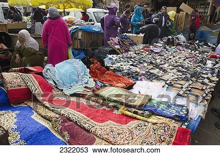 Shoppers looking at colorful textiles at street market; Old Medina, Casablanca, Morocco View Large Photo Image Stock Image - Shoppers looking at colorful textiles at street market; Old Medina, Casablanca, Morocco. Fotosearch