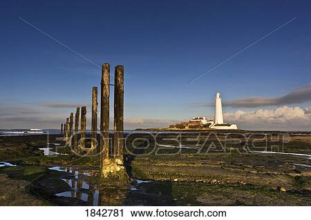 Stock Image - Shore And Lighthouse In Distance; Whitley Bay, Northumberland, England. Fotosearch