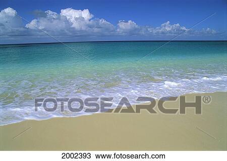 Stock Image - Shore Break Waters With White Wash, Calm And Clear Horizon Puffy White Clouds. Fotosearch