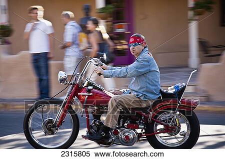 Stock Photography - Side view of man on riding up Canyon Road; Santa Fe, New Mexico, USA. Fotosearch
