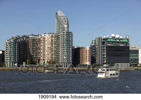 Sightseeing Boat Passing Office Towers At Canary Wharf, London, Uk View Large Photo Image Picture - Sightseeing Boat Passing Office Towers At Canary Wharf, London, Uk. Fotosearch