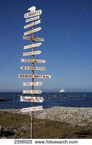 Stock Photography - Sign at Bear Island, with cruise ship in distance; Svalbard, Norway. Fotosearch