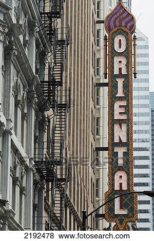 Stock Photo - Sign Saying Oriental With A Fire Escape Staircase On The Side Of A Building; Chicago Illinois United States Of America. Fotosearch