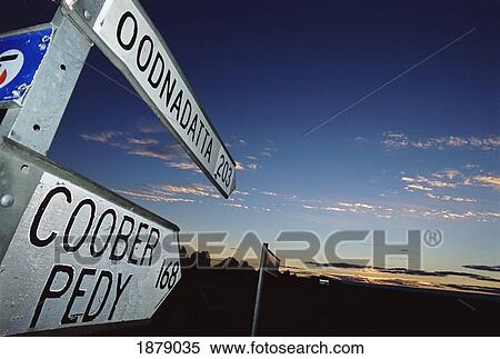 Stock Photography - Signpost For Coober Pedy And Oodnadatta At Sunset. Fotosearch