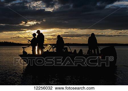 Silhouette of a family fishing from their motorboat on a lake at sunset in Northern Ontario; Ontario, Canada View Large Photo Image Stock Image - Silhouette of a family fishing from their motorboat on a lake at sunset in Northern Ontario; Ontario, Canada. Fotosearch