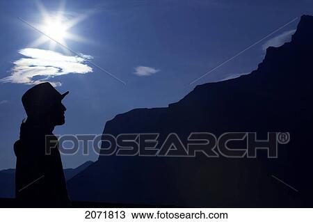 Stock Image - Silhouette Of A Man At Sunrise, Banff, Alberta. Fotosearch