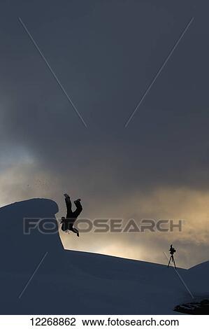 Silhouette of a man somersaulting of a snow ledge, St. Moritz, Switzerland View Large Photo Image Stock Image - Silhouette of a man somersaulting of a snow ledge, St. Moritz, Switzerland. Fotosearch