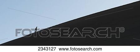 Stock Photo - Silhouette Of A Person Climbing A Sand Dune; Jiuquan, Gansu, China. Fotosearch