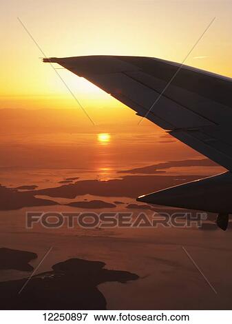 Silhouette of airplane tail in flight at sunset; British Columbia, Canada View Large Photo Image Stock Photo - Silhouette of airplane tail in flight at sunset; British Columbia, Canada. Fotosearch