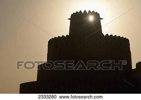 Stock Image - Silhouette Of Al Jahili Fort; Al Ain, Abu Dhabi, United Arab Emirates. Fotosearch