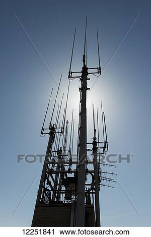 Stock Image - Silhouette of antennas and communications structure; New York City, New York, United States of America. Fotosearch