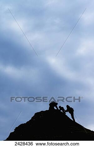 Silhouette of couple helping young boy climb hill; Kerrera Island, Scotland View Large Photo Image Stock Photograph - Silhouette of couple helping young boy climb hill; Kerrera Island, Scotland. Fotosearch