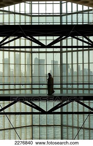Silhouette of couple walking past large window in the Museum of Islamic Art in front of the modern city skyline of Doha; Doha, Qatar View Large Photo Image Stock Image - Silhouette of couple walking past large window in the Museum of Islamic Art in front of the modern city skyline of Doha; Doha, Qatar. Fotosearch