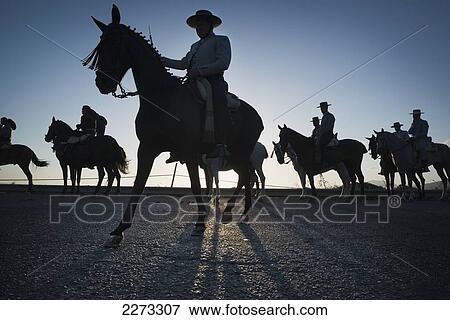 Stock Photo - Silhouette of cowboys on horses; tarifa cadiz andalusia spain. Fotosearch