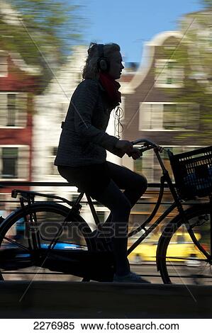 Silhouette of cyclist going past canal and gabled houses; Amsterdam, Holland View Large Photo Image Stock Photography - Silhouette of cyclist going past canal and gabled houses; Amsterdam, Holland. Fotosearch