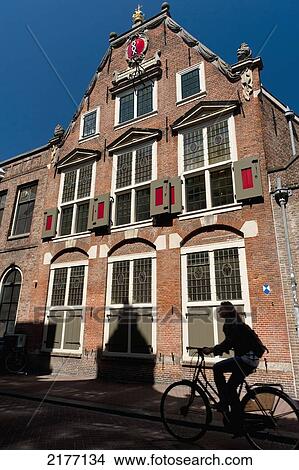 Silhouette Of Cyclist Going Past Traditional Dutch Houseamsterdam, Holland. View Large Photo Image Picture - Silhouette Of Cyclist Going Past Traditional Dutch Houseamsterdam, Holland.. Fotosearch
