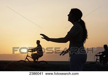 Silhouette of cyclists and a woman doing yoga at sunrise; California, United States of America View Large Photo Image Stock Image - Silhouette of cyclists and a woman doing yoga at sunrise; California, United States of America. Fotosearch