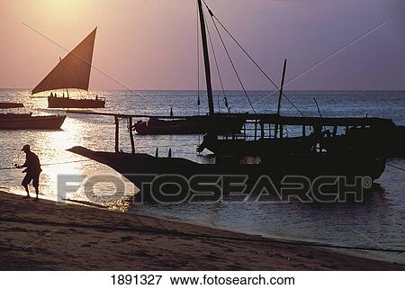 Stock Photo - Silhouette Of Fisherman On Stone Town Beach. Fotosearch
