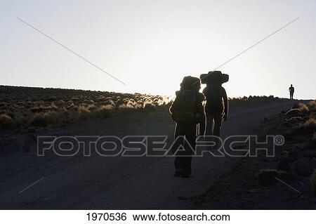 Stock Photograph - Silhouette Of Hikers In The Miscanti And Miniques Lagoon Area, Antofagasta Region, Chile. Fotosearch