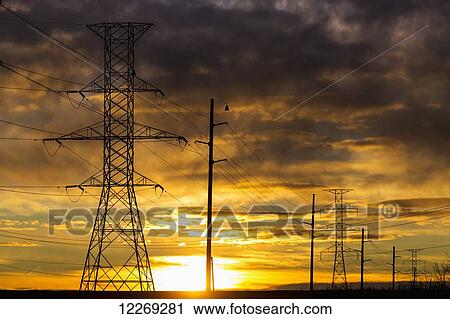 Silhouette of large metal powerline towers with colourful clouds and sun; Calgary, Alberta, Canada View Large Photo Image Stock Image - Silhouette of large metal powerline towers with colourful clouds and sun; Calgary, Alberta, Canada. Fotosearch